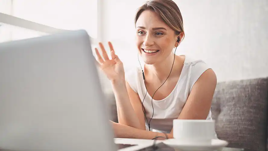 Woman watching a product demo on her laptop.